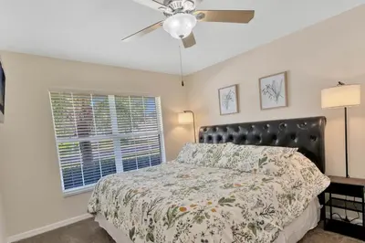 a bedroom with a bed and a ceiling fan at Spacious 5-Bedroom 4-Bath Pool & Spa Villa in Emerald Island Resort in Kissimmee