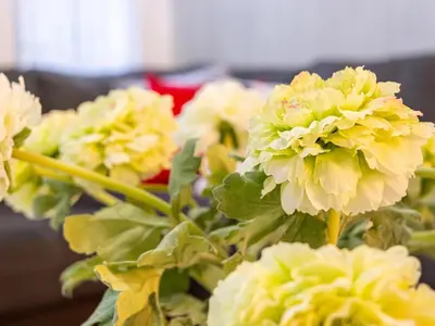 a bunch of yellow flowers in a vase at The Enchanted luxe Townhome in Kissimmee