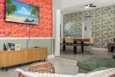 a living room with a table and a dining room at Game Filled Orlando Retreat with Patio and Grill in Orlando