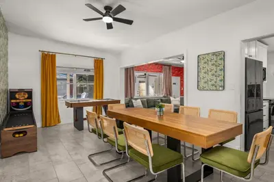 a kitchen and dining room with a wooden table and chairs at Game Filled Orlando Retreat with Patio and Grill in Orlando