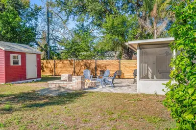 a backyard with a shed and a table and chairs at Game Filled Orlando Retreat with Patio and Grill in Orlando