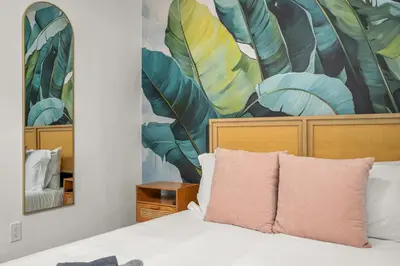 a bedroom with a bed with a painting on the wall at Game Filled Orlando Retreat with Patio and Grill in Orlando