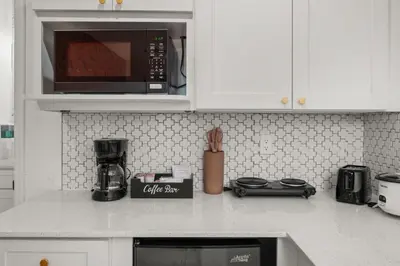a kitchen counter with a coffee shop sign on it at Charming Private Studio Near Everything Orlando in Orlando