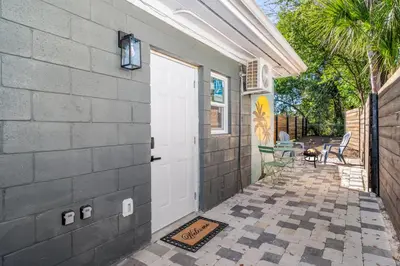 a white door on a house with a patio at Charming Private Studio Near Everything Orlando in Orlando