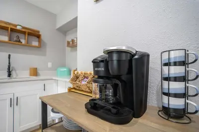 a coffee maker sitting on a table in a kitchen at Fireplace and Lake View Just 10 Minutes to Downtown Near Parks in Orlando