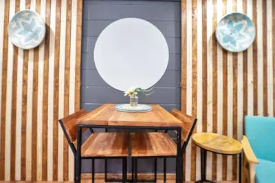 a table with a mirror and two plates on a wall at Peaceful Lake View Retreat Near Parks 10 Minutes to Downtown in Orlando