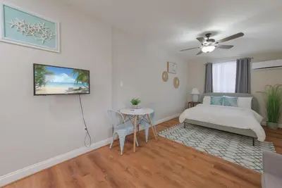 a bedroom with a bed and a table and a couch at Studio in the heart of Orlando in Orlando