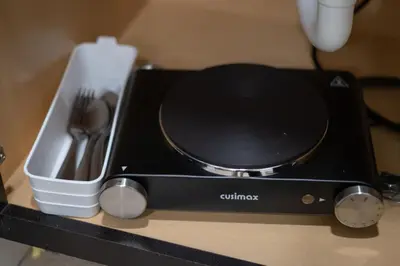 a toaster oven sitting on a counter with utensils at Comfy studio in Central Orlando in Orlando
