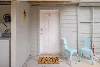 two blue chairs sitting in front of a door at Comfy studio in Central Orlando in Orlando