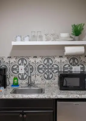 a kitchen counter with a sink and a microwave at Comfy studio in Central Orlando in Orlando