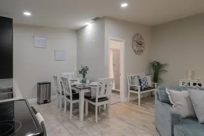 a living room with a table and a couch at Cozy 2 bedroom home in Orlando in Orlando