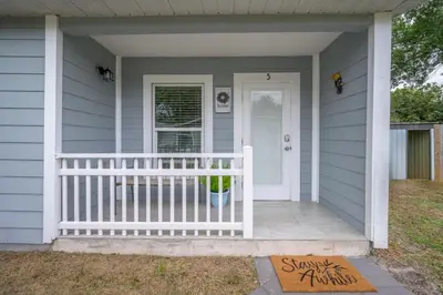 a house with a white door and a porch at Private Studio near parks and Downtown in Orlando