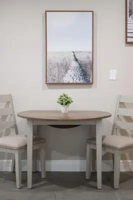 a wooden table with two chairs and a picture on the wall at Comfortable 1 bedroom home in Orlando