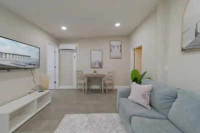 a living room with a blue couch and a table at Comfortable 1 bedroom home in Orlando