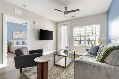 a living room with a couch and a table at Landing Incredible 1BD Clubhouse Gym in Orlando