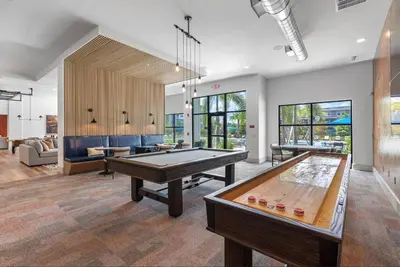 a living room with a ping pong table in it at Landing Chic 1BD Gym Pool in Sanford
