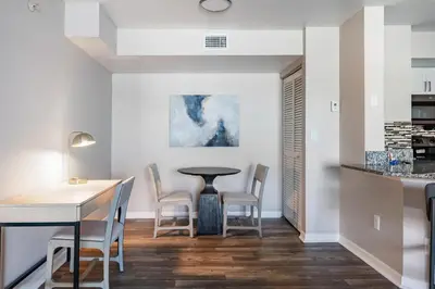 a kitchen and dining room with a table and chairs at Landing Chic 1BD Gym in Orlando