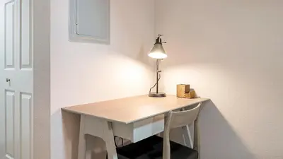 a desk with a lamp and a chair in a room at Landing Chic 1BD Gym in Orlando