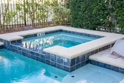 a swimming pool with a bench in the middle at Encore Resort luxury house 8 bedrooms, pool and spa in Orlando