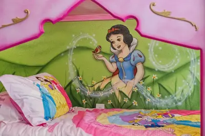 a bedroom with a princess painting on the wall at Arcade and Pool Villa, 4 km to Disney in Orlando