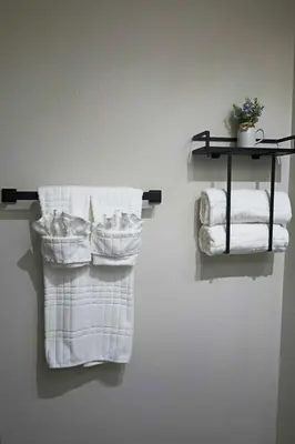 two towels are hanging on a wall in a bathroom at Salos Retreat, beautiful and peaceful stay in Saint Cloud