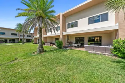 a palm tree in front of a building at Bright and Modern Townhome at Magic Village – Superb Disney Location in Orlando