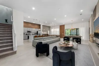 a living room with a couch and a table at Brand New Modern State of the Art Home! Sleeps 31 in Kissimmee