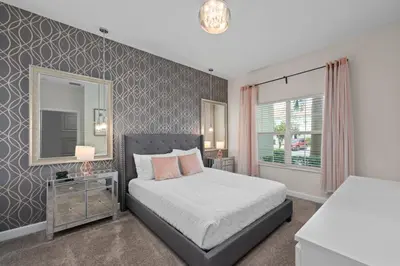 a bedroom with a bed and a mirror at Chic Resort Getaway – 15 Min to Disney in Kissimmee