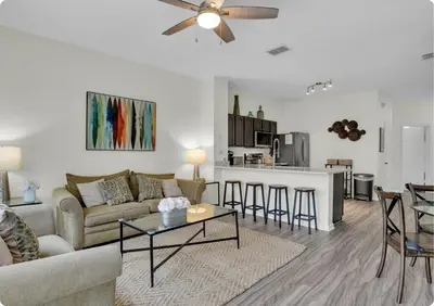 a living room and kitchen with a couch and a table at Windsor Hills Resort in Orlando
