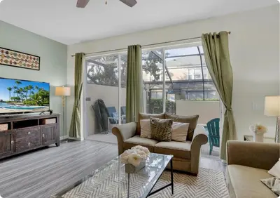a living room with a couch and a tv at Windsor Hills Resort in Orlando