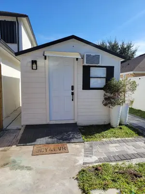 a white garage with a sign in front of it at A cozy stay with everything you need! in Kissimmee