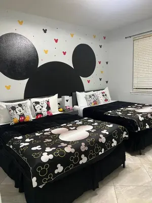 a bedroom with two beds and a wall with hearts at Magical Apartment DisneyFree ShuttleFree parking in Kissimmee