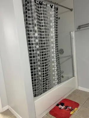 a shower with a glass door in a bathroom at Magical Apartment DisneyFree ShuttleFree parking in Kissimmee