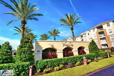 a hotel with palm trees in front of a building at The Epic 11 Vista Cay Resort Orlando Florida in Orlando