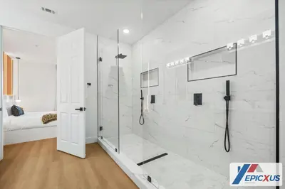 a white bathroom with a shower with a glass door at The Epic 3 Lake View Vista Cay Resort Orlando Florida in Orlando