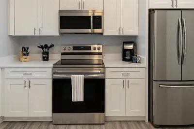 a kitchen with a stove and a microwave at Disney-Area 4BR | Pool + Patio in Kissimmee
