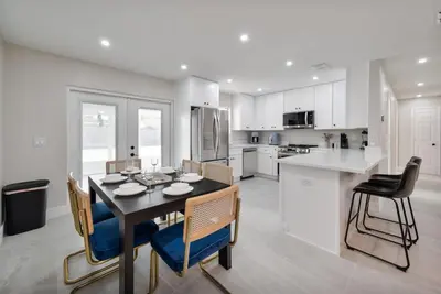 a kitchen and dining room with a table and chairs at Downtown Home with Basketball, Firepit and Just 20 Miles to Disney in Saint Cloud
