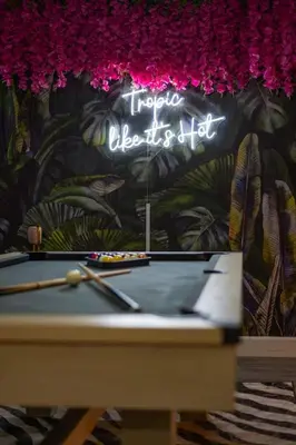 a pool table with a sign that reads trico libretto illegal at 10 Minutes to Downtown with Jacuzzi, Pool Table, Ping Pong, and BBQ in Orlando