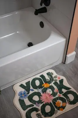 a rug on the floor next to a bath tub at Cozy Orlando Studio with Jacuzzi, Fire Pit, and BBQ in Orlando