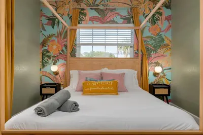 a bedroom with a white bed with a window at Cozy Orlando Studio with Jacuzzi, Fire Pit, and BBQ in Orlando