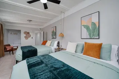 a bedroom with two beds and a ceiling fan at Stylish 2BR Home Near Disney and Universal Orlando in Orlando