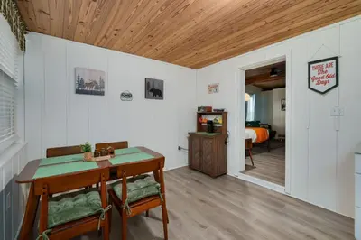 a room with a table and chairs and a bedroom at Modern Downtown Orlando Studio in a Prime Location in Orlando