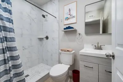 a bathroom with a toilet and a sink and a shower at Hip Orlando Studio Nearby Restaurants and Parks in Orlando