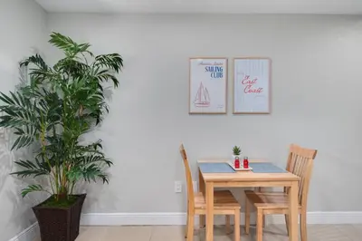 a dining room table with two chairs and a plant at Hip Orlando Studio Nearby Restaurants and Parks in Orlando