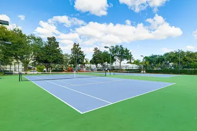 a tennis court with two tennis courts at Resort Perks! Family Home 4 Mi to Disney World in Kissimmee