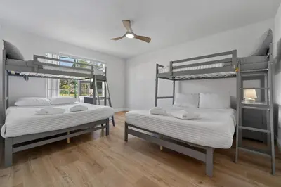 a bedroom with two bunk beds and a ceiling fan at Bright Ground Floor Condo Minutes to Parks in Kissimmee