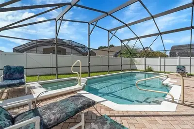 a large swimming pool with a glass roof at 5BR 4BA Near Disney, Pool, Sauna, Pets Allowed in Kissimmee