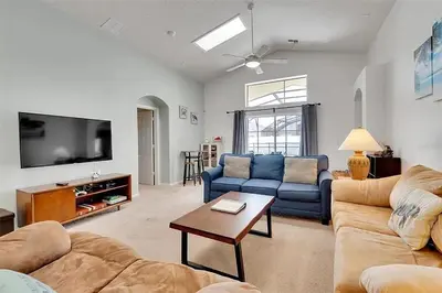 a living room with two couches and a tv at 5BR 4BA Near Disney, Pool, Sauna, Pets Allowed in Kissimmee