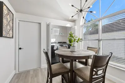 a dining room with a table and chairs at Magical Hideaway at Kissimmee by Shine Villas villa in Kissimmee