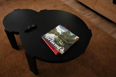 a black table with a book and a remote control at Suites by The Wellborn in Orlando